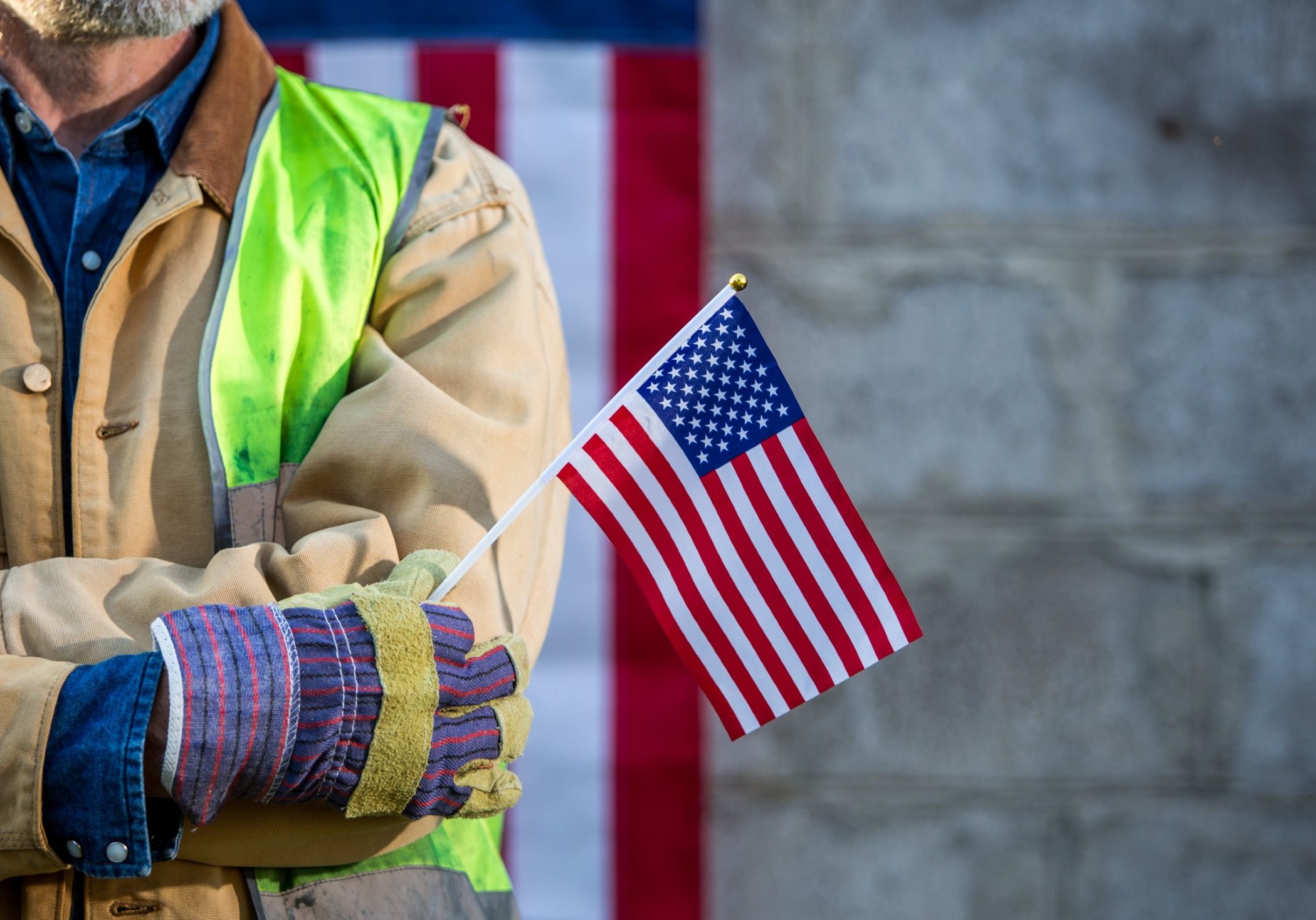 A serious worker man and american flag